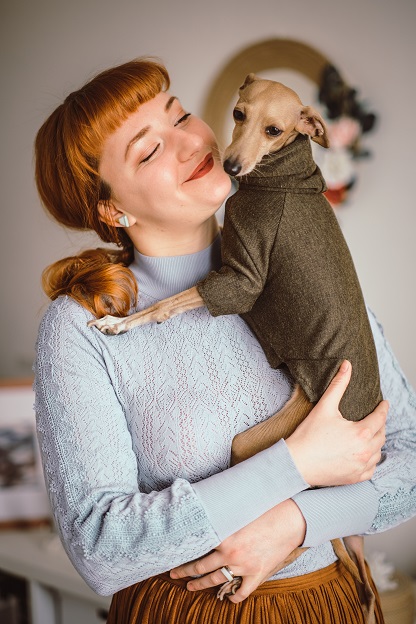 brown italian greyhound being held